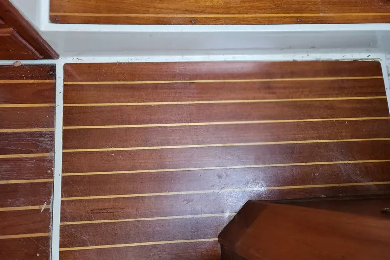 Slide: The Image of Teak wood flooring on 1985 Catalina 36 sailboat interior. - 46