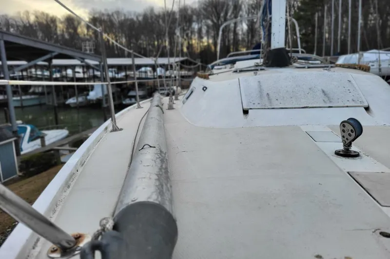 Slide: The Image of 1985 Catalina 36 sailboat deck view at marina, overcast sky. - 49