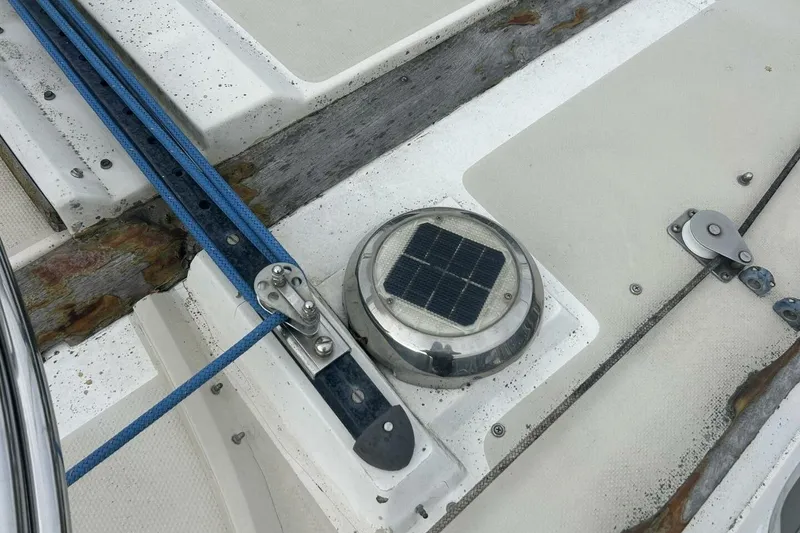 Slide: The Image of Deck of 1985 Catalina 36 sailboat with solar vent and blue rope. - 50