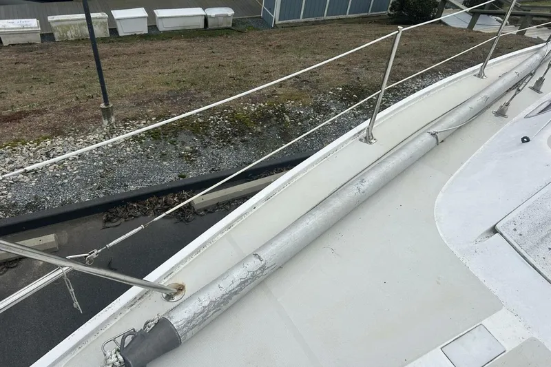 Slide: The Image of 1985 Catalina 36 sailboat deck with railing and rolled sail. - 53
