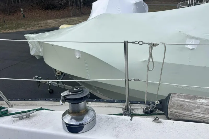 Slide: The Image of Catalina 36 sailboat, 1985 model, covered and docked, with visible winch and rigging. - 57