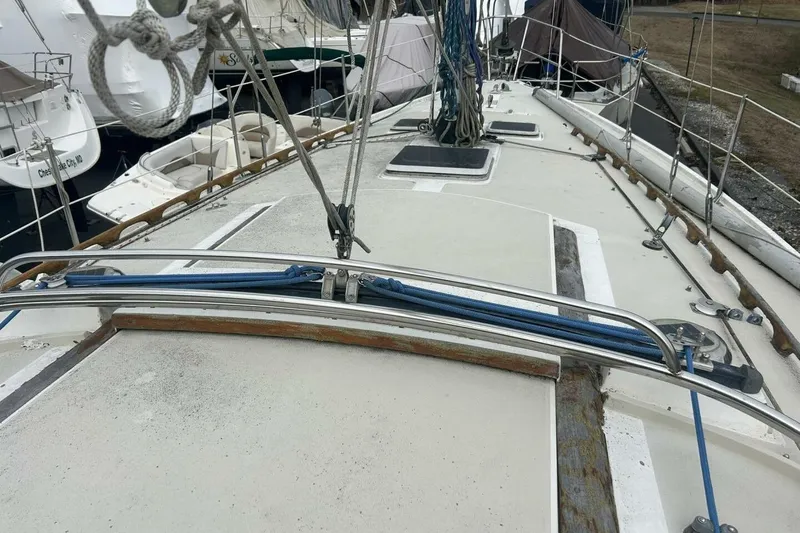 Slide: The Image of 1985 Catalina 36 sailboat deck with rigging and ropes in a marina. - 6