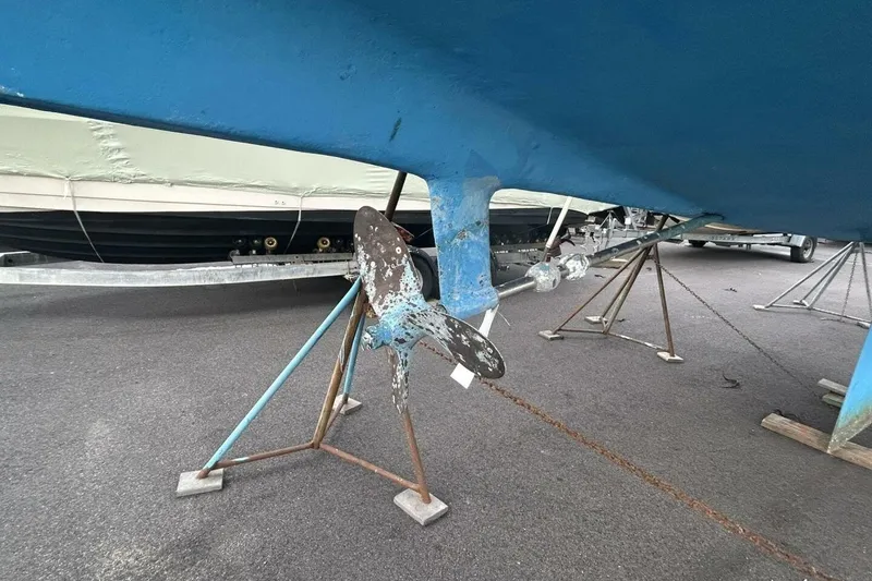 Slide: The Image of 1985 Catalina 36 sailboat hull and propeller on stands, ready for maintenance. - 61