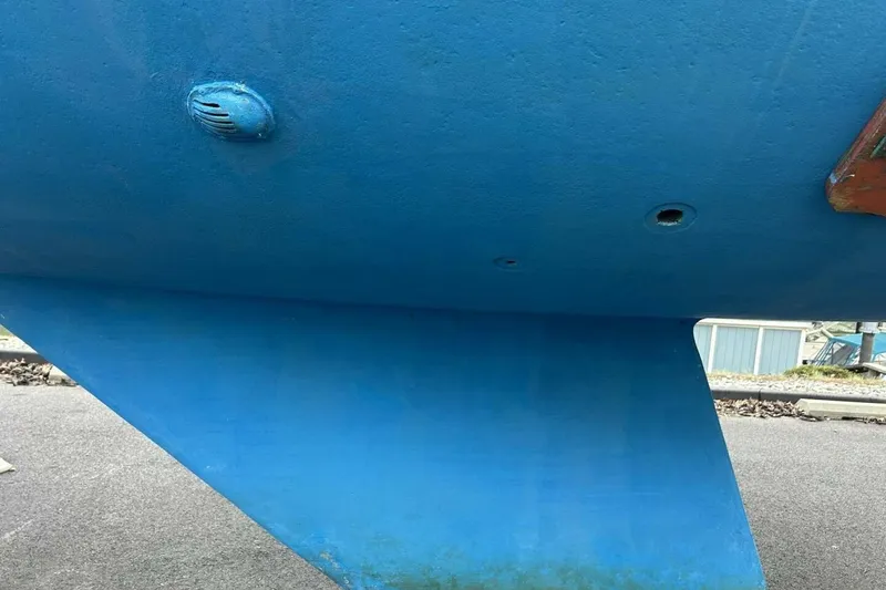 Slide: The Image of Blue hull of a 1985 Catalina 36 sailboat, showing keel and through-hull fittings. - 63