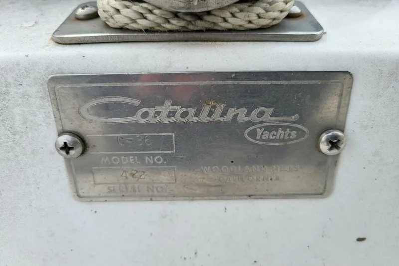 Slide: The Image of Plaque of 1985 Catalina 36 yacht, model number 422, with visible screws and rope. - 68