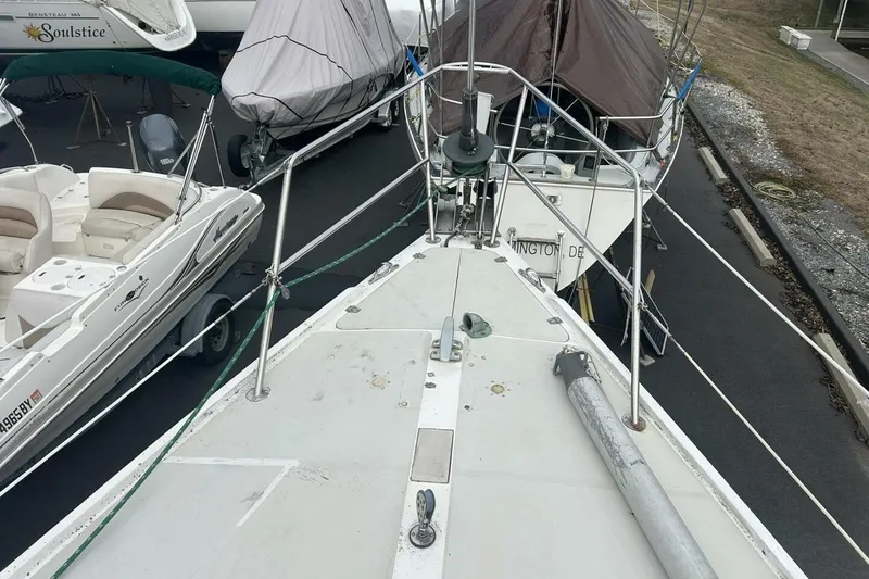 Slide: The Image of 1985 Catalina 36 sailboat on dry dock, surrounded by other boats. - 7