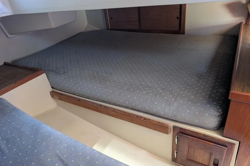 Slide: The Image of Interior cabin of a 1985 Catalina 36 sailboat with cushioned sleeping area. - 70