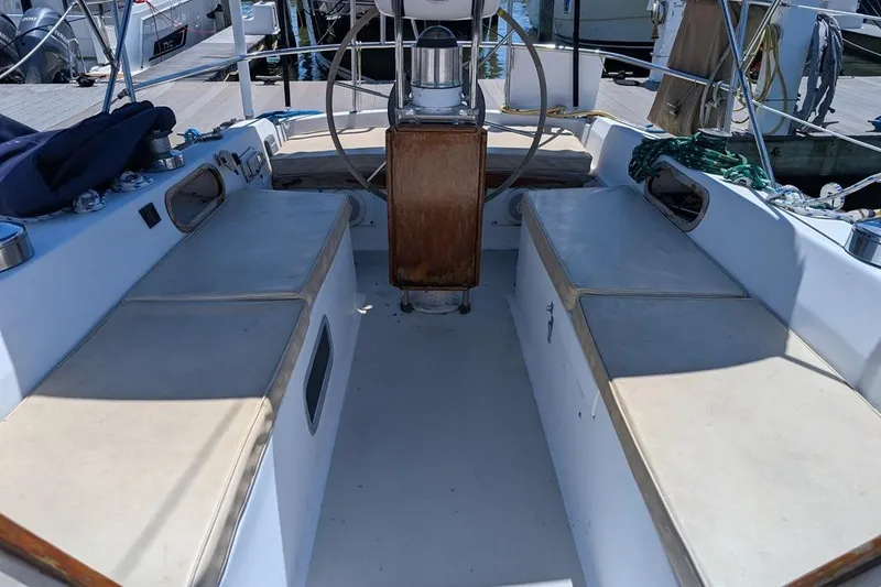 Slide: The Image of Cockpit of a 1985 Catalina 36 sailboat with seating and steering wheel. - 76
