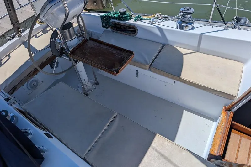 Slide: The Image of Cockpit of a 1985 Catalina 36 sailboat with seating and steering wheel. - 81