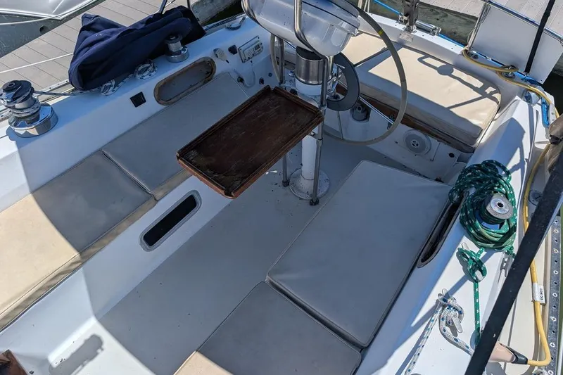 Slide: The Image of Cockpit of a 1985 Catalina 36 sailboat with seating and steering wheel. - 82