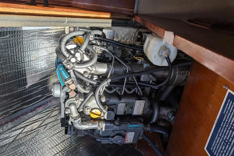 Slide: The Image of Engine compartment of a 1985 Catalina 36 sailboat, showcasing intricate mechanical components. - 86