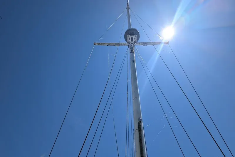 Slide: The Image of Mast of 1985 Catalina 36 sailboat against clear blue sky and bright sun. - 89