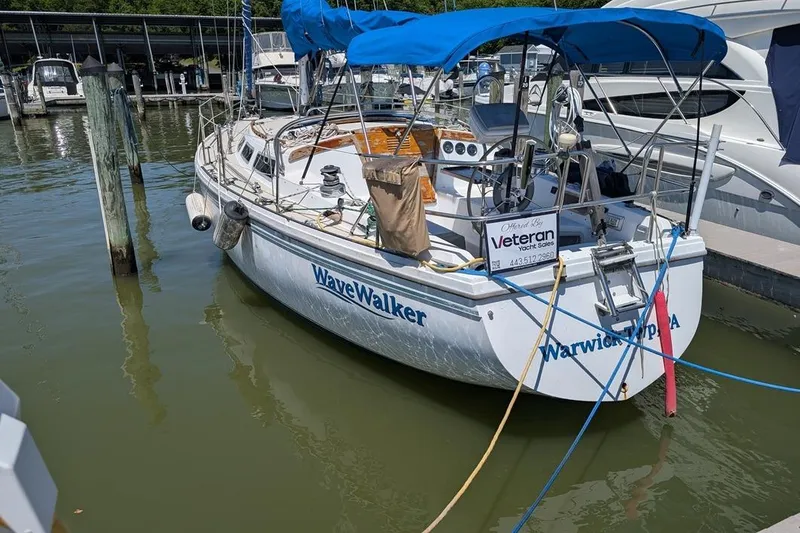 Slide: The Image of Catalina 36 sailboat from 1985, named WaveWalker, docked at a marina. - 92
