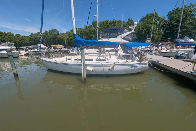 Slide: The Image of 1985 Catalina 36 sailboat "Wave Walker" docked at a marina on a sunny day. - 94
