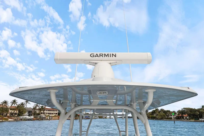 Slide: The Image of 2026 Yellowfin 32 Offshore boat with Garmin radar, clear sky background. - 10