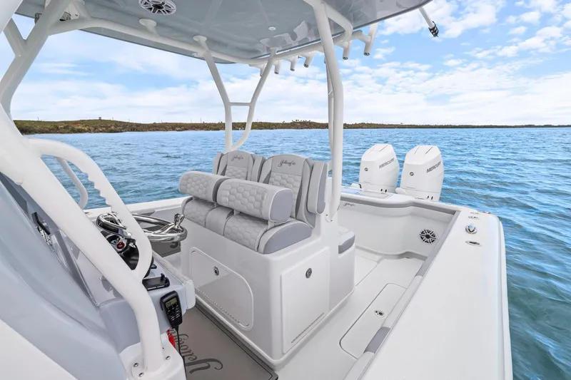 Slide: The Image of 2026 Yellowfin 32 Offshore boat interior with dual Mercury engines on open water. - 18