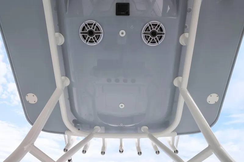 Slide: The Image of 2026 Yellowfin 32 Offshore boat roof with speakers and rod holders against blue sky. - 20