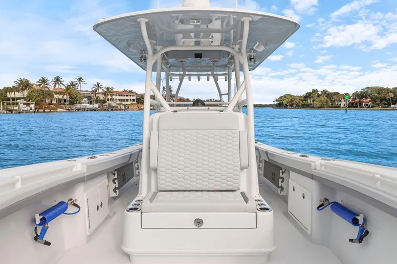 Slide: The Image of 2026 Yellowfin 32 Offshore boat interior with ocean view, featuring white seating and clear blue skies. - 21