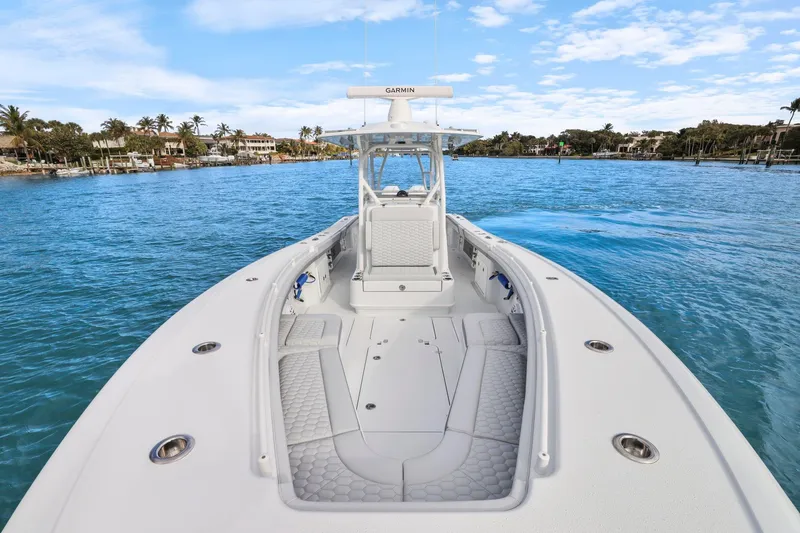 Slide: The Image of 2026 Yellowfin 32 Offshore boat on calm blue water, clear sky background. - 22