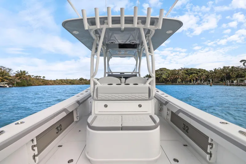 Slide: The Image of 2026 Yellowfin 32 Offshore boat on a scenic waterway with clear skies. - 26