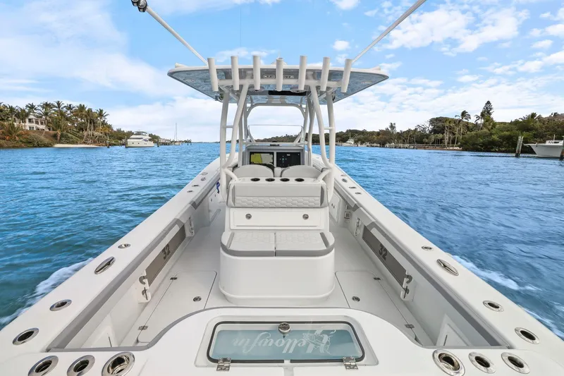 Slide: The Image of 2026 Yellowfin 32 Offshore boat on a scenic waterway, clear skies above. - 28