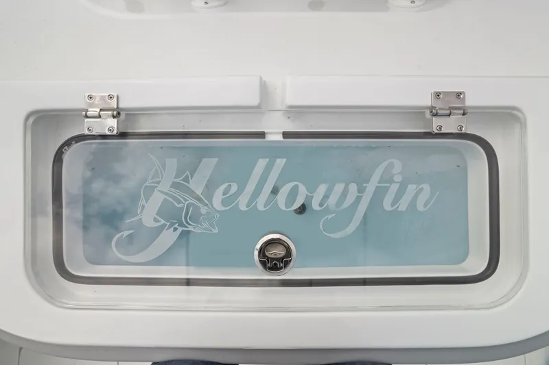 Slide: The Image of 2026 Yellowfin 32 Offshore boat livewell with logo and secure latch. - 29