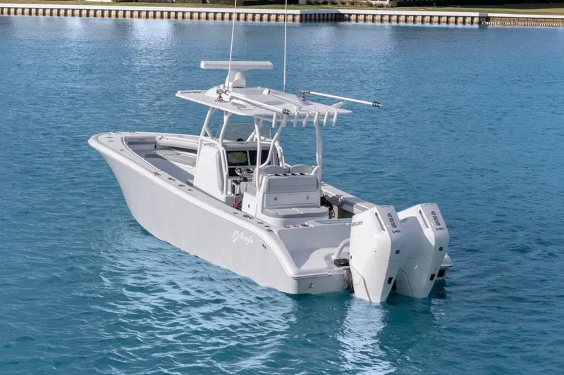 Slide: The Image of 2026 Yellowfin 32 Offshore boat on clear blue water, featuring dual outboard engines. - 3