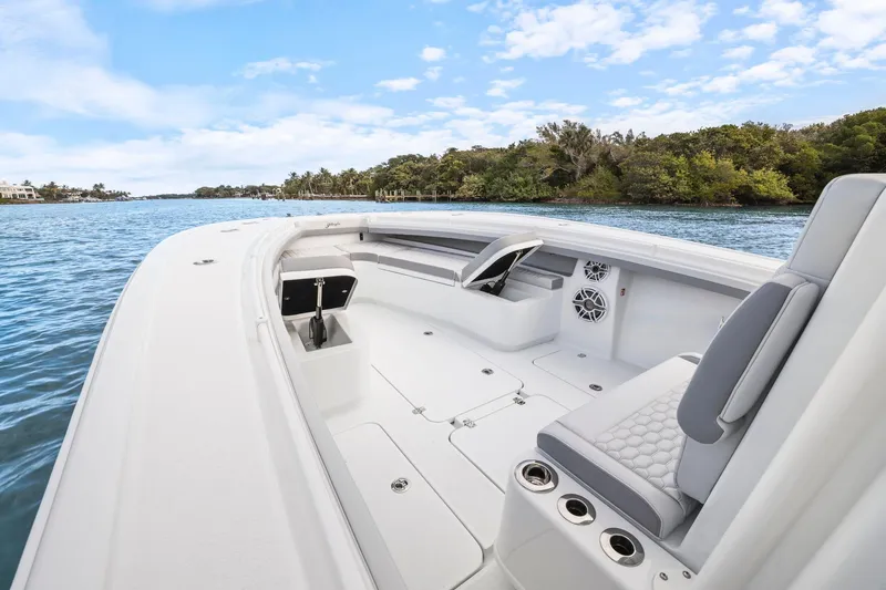 Slide: The Image of 2026 Yellowfin 32 Offshore boat interior, featuring sleek seating and modern design on calm waters. - 32