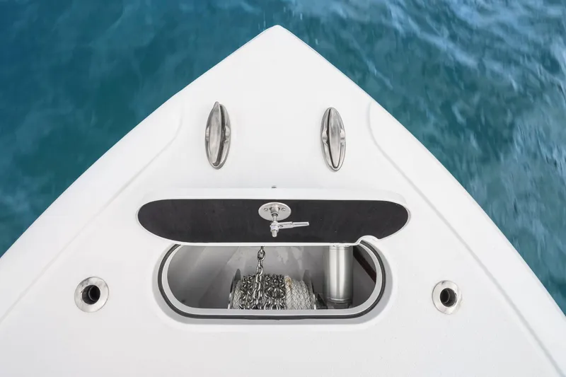Slide: The Image of Bow of 2026 Yellowfin 32 Offshore boat with anchor storage, on blue water. - 39