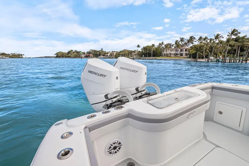 Slide: The Image of 2026 Yellowfin 32 Offshore boat with Mercury engines on a scenic waterway. - 43