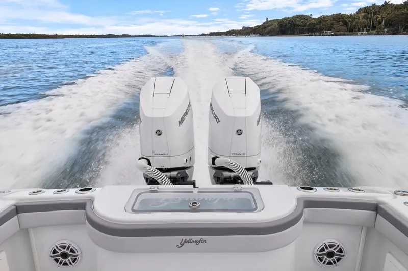 Slide: The Image of 2026 Yellowfin 32 Offshore boat with dual Mercury engines cruising on open water. - 45