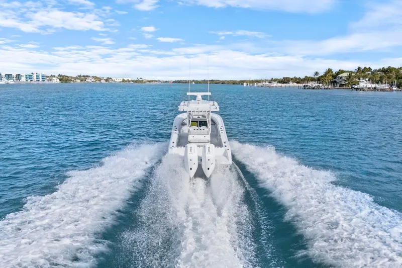 Slide: The Image of 2026 Yellowfin 32 Offshore boat cruising on clear blue water, leaving a wake behind. - 46