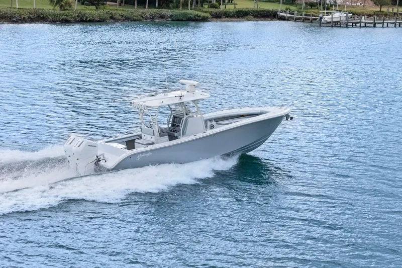 Slide: The Image of 2026 Yellowfin 32 Offshore boat cruising on a serene blue lake. - 49