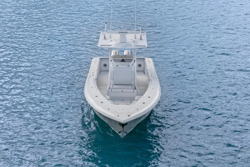 Slide: The Image of 2026 Yellowfin 32 Offshore boat on calm blue water, aerial view. - 6