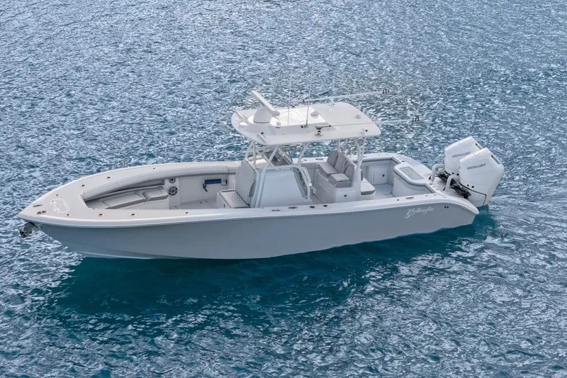 Slide: The Image of 2026 Yellowfin 32 Offshore boat on clear blue water, featuring twin Mercury engines. - 7