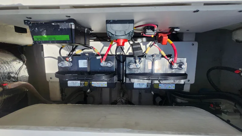 Slide: The Image of Battery compartment of the 2024 Cobia 220 Dual Console boat. - 14
