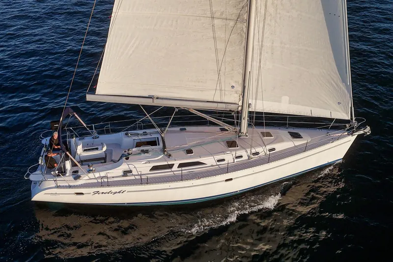 Slide: The Image of Sailing yacht Catalina 470, 1999 model, cruising on open water with full sails. - 10