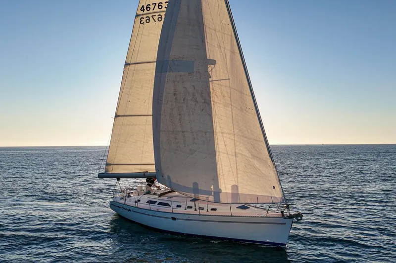 Slide: The Image of Sailing yacht Catalina 470 from 1999 gliding on open sea at sunset. - 13