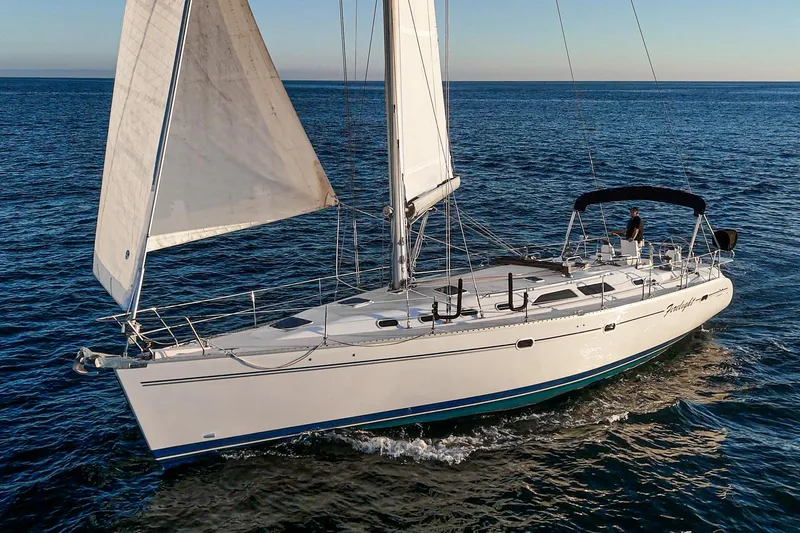 Slide: The Image of Sailing yacht Catalina 470, 1999 model, cruising on open sea under clear skies. - 14