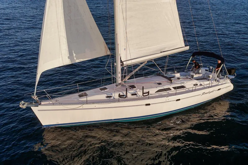 Slide: The Image of Sailing yacht Catalina 470, 1999 model, cruising on open water with full sails. - 15