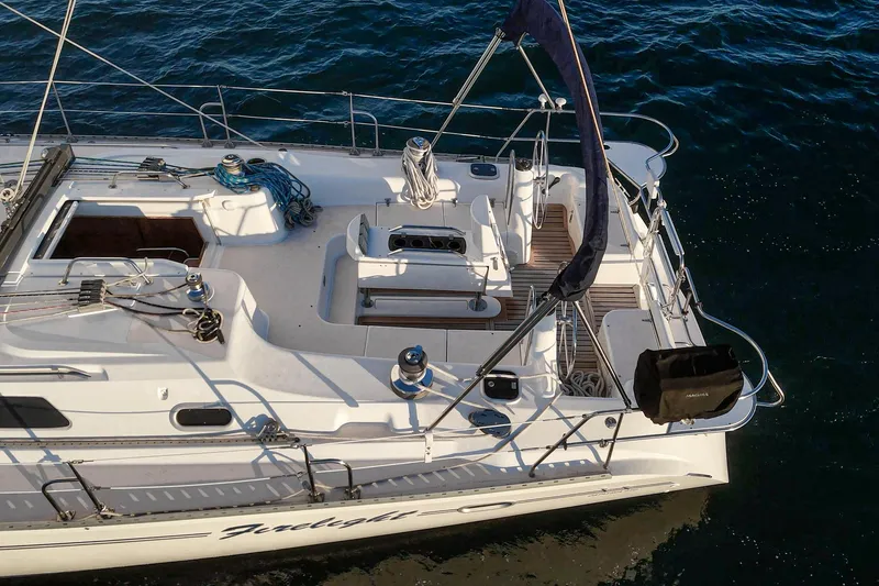 Slide: The Image of Aerial view of 1999 Catalina 470 sailboat on water, showcasing deck and rigging. - 20