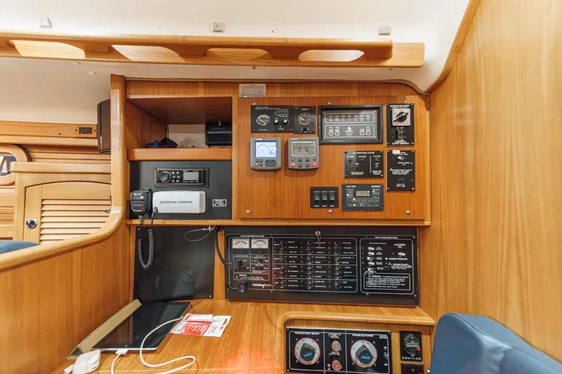 Slide: The Image of Control panel inside a 1999 Catalina 470 yacht, featuring navigation and communication equipment. - 30