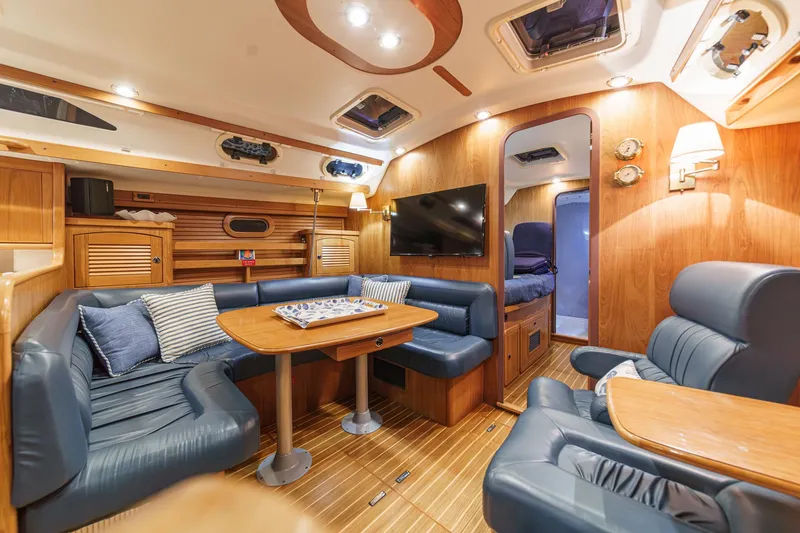 Slide: The Image of Luxurious interior of 1999 Catalina 470 yacht with cozy seating and elegant wood finishes. - 33