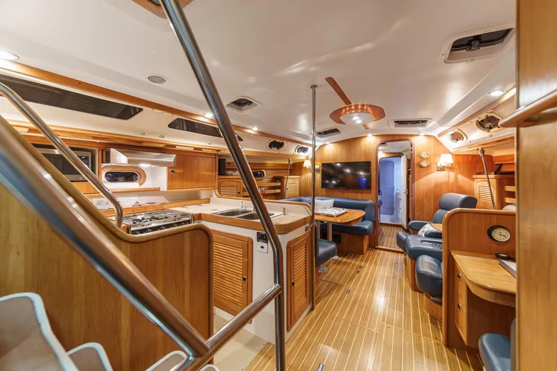 Slide: The Image of Luxurious interior of a 1999 Catalina 470 yacht with wood finishes and modern amenities. - 36
