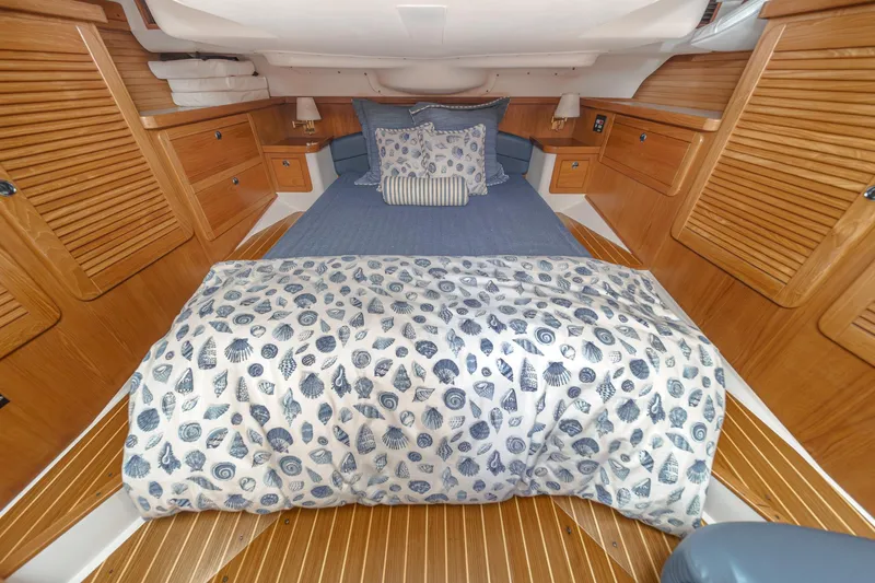 Slide: The Image of Cozy cabin interior of 1999 Catalina 470 sailboat with nautical-themed bedding. - 39
