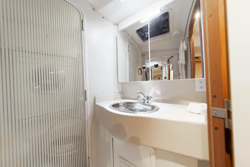 Slide: The Image of Bathroom interior of 1999 Catalina 470 yacht with sink and mirror. - 48