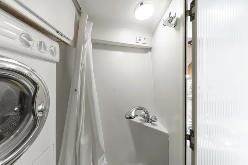 Slide: The Image of Compact bathroom with shower and washing machine in 1999 Catalina 470 yacht. - 49