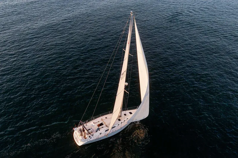 Slide: The Image of Aerial view of 1999 Catalina 470 sailboat navigating calm ocean waters. - 5