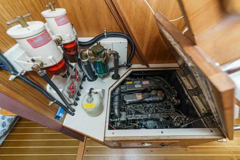 Slide: The Image of Engine compartment of a 1999 Catalina 470 sailboat, showcasing detailed mechanical components. - 50