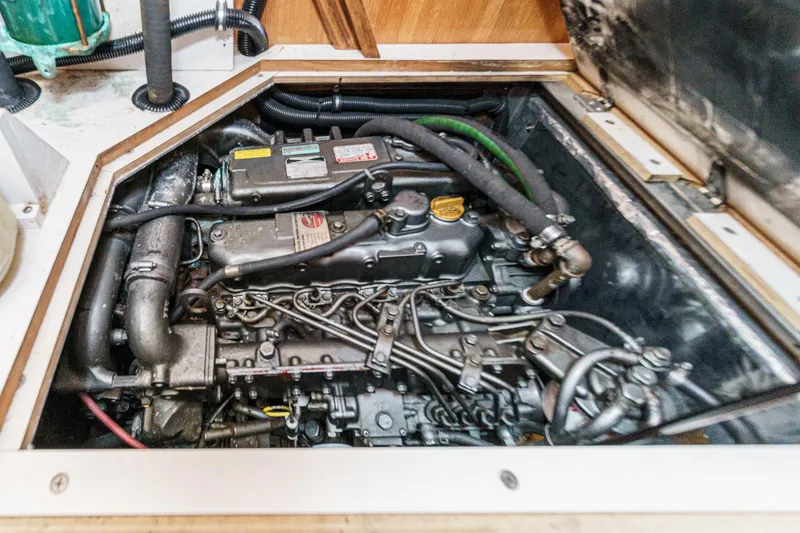 Slide: The Image of Engine compartment of a 1999 Catalina 470 sailboat, showcasing detailed mechanical components. - 51